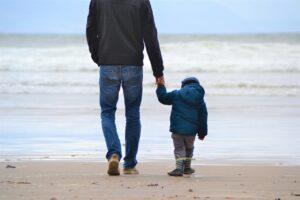 Father walking with son holding hands